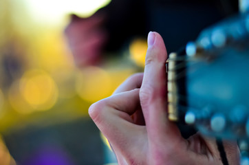 man shows guitar chords. workmanship