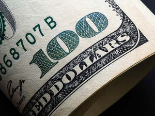 One hundred dollars corner of banknote with magnification