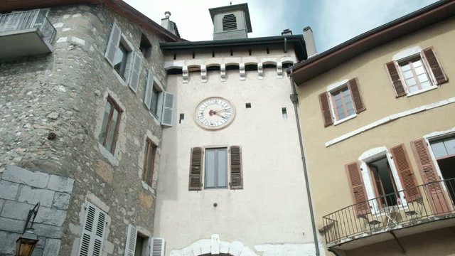 Forward push in first person POV view camera tilt up to old town clock tower in Annecy, France