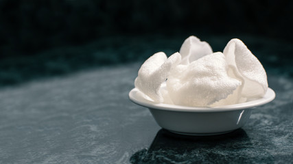 Some prank crackers served in a white wood. Chinese food and empty copy space for the Editor's text.