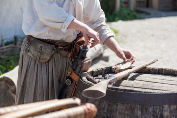 Loading a powder to the barrel of an antique shotgun