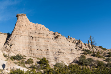 High, steep rock formation showing layers of strata at Kasha-Katuwe Tent Rocks National Monument