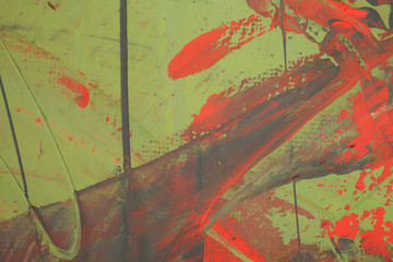 Green abstract background with red stains close up.