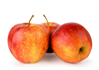 Three ripe red apples close up on a white. Isolated.