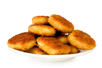 Fried nuggets in a white plate close-up.