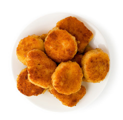 Fried nuggets in a plate on a white. The view from the top.