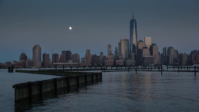 Moon rises in the NYC lower Manhattan Skyline