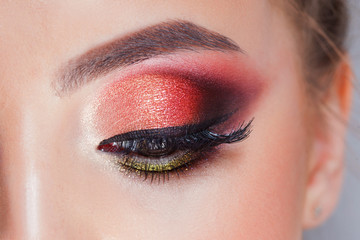 Amazing Bright eye makeup in luxurious scarlet shades. Pink and blue color, colored eyeshadow - obrazy, fototapety, plakaty