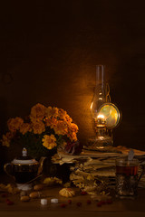 Still life with a kerosene lamp, tea in a glass
