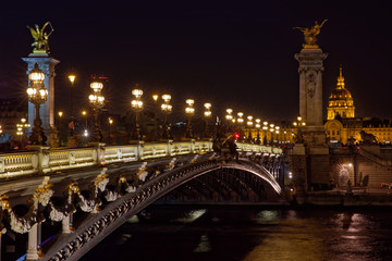 Fototapeta na wymiar Paris, France - November 17, 2018: Alexandre 3 bridge and Invalide dome at night in Paris