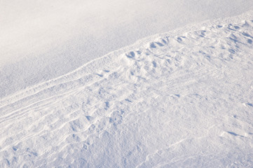 Wind sculpted patterns on snow surface.