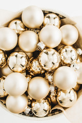 Christmas composition with golden decoration balls on white background. Flat lay, top view.