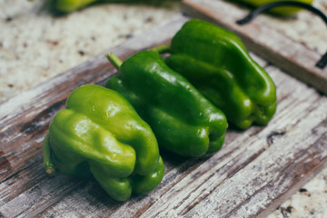 Set of green bell pepper on wooden vintage table. 