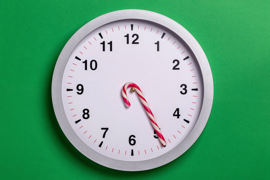 Christmas clock with candy cane hands shows five o'clock