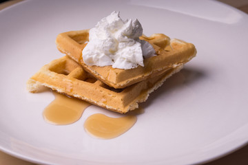 Waffles with syrup and whipped cream