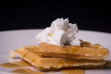 Waffles with syrup and whipped cream