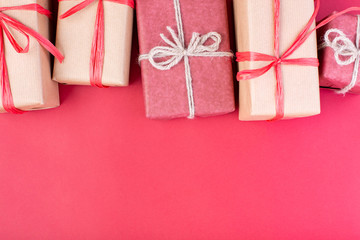 Christmas composition. Christmas red decorations, stars and gift boxes on red background. Flat lay, top view, space for the text