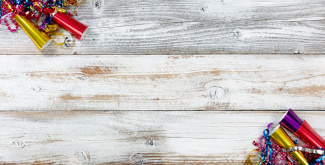 Happy New Year Celebration with party objects in right and left corners on white rustic wooden boards