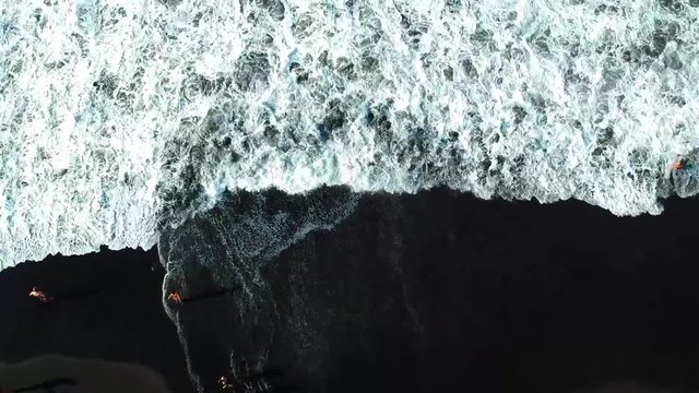 Aerial drone footage at playa de el bollullo. One of the most beautiful black sand beach in Tenerife.