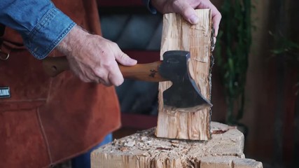 Medium Shot of Craftsman Cutting Wood With Hatchet