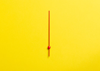 red hour hand on yellow background
