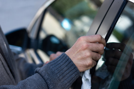 Man Cleaning Bird Droppings In His Car