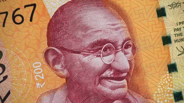 Mahatma Gandhi face on India 200 rupee 2017 banknote rotating, Indian  money closeup. 4K UHD video footage