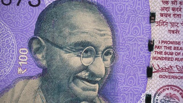 Mahatma Gandhi face on India 100 rupee (2018) banknote rotating, Indian  money closeup. 4K UHD video footage