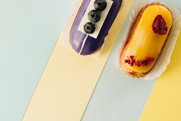 Set of delicious eclairs with glaze, colorful dessert