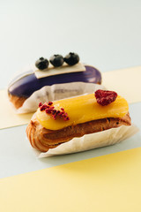 Set of delicious eclairs with glaze, colorful dessert