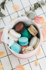Composition of delicious macaroons in round gift box, sweet dessert