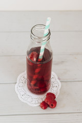 Delicious homemade raspberry lemonade with drinking straw