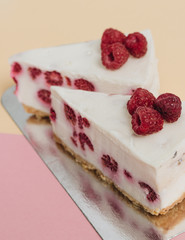 Two pieces of delicious cake with raspberries, sweet dessert