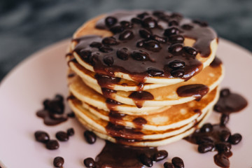 Stack of delicious homemade pancakes with sauce