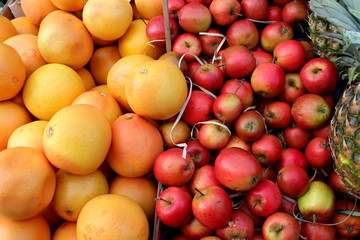Lots of fresh organic red apples and juicy oranges on the market  pattern background