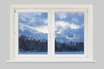 View from the window to the winter landscape with a frozen lake