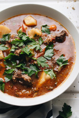 Delicious tomato soup with parsley, meat and pepper