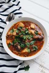 Delicious tomato soup with parsley, meat and pepper