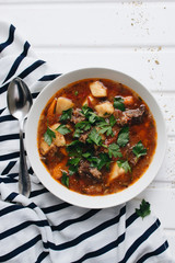 Delicious tomato soup with parsley, meat and pepper
