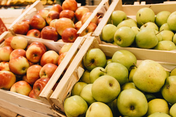 pile of fresh ripe green apples in boxes at market