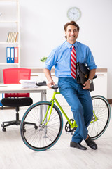 Young businessman using bike to commute to the office