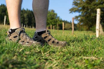 Man in sport shoes in the grass. Czech Republic