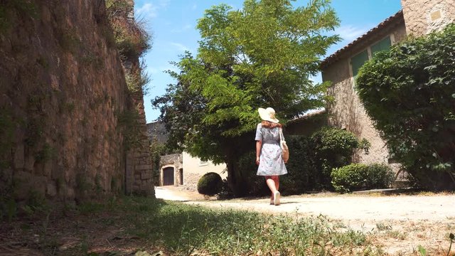 Girl walks through the abandoned village of Opped le Vieux