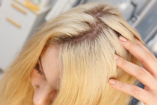 Woman Showing Blonde Hair Roots