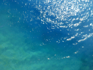Sea surface aerial view. Bird eye photo of turquoise waves and water surface texture.