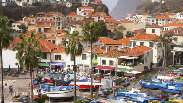 View of C&acirc;mara de Lobos in Madeira with Cape Gir&atilde;o on the background and boats at the marina