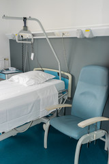 Health,treatment and medical concept-bed and equipment in the hospital room.