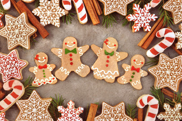 Homemade gingerbread man cookies, festive Christmas and New Year sweeties background card, toned