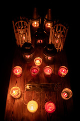 Mix candles, incense and lanterns on rustic wood table