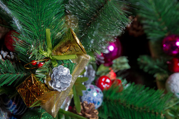 A Christmas ball hangs on the background of a clock. It's time for a new year. Multicolored glare...